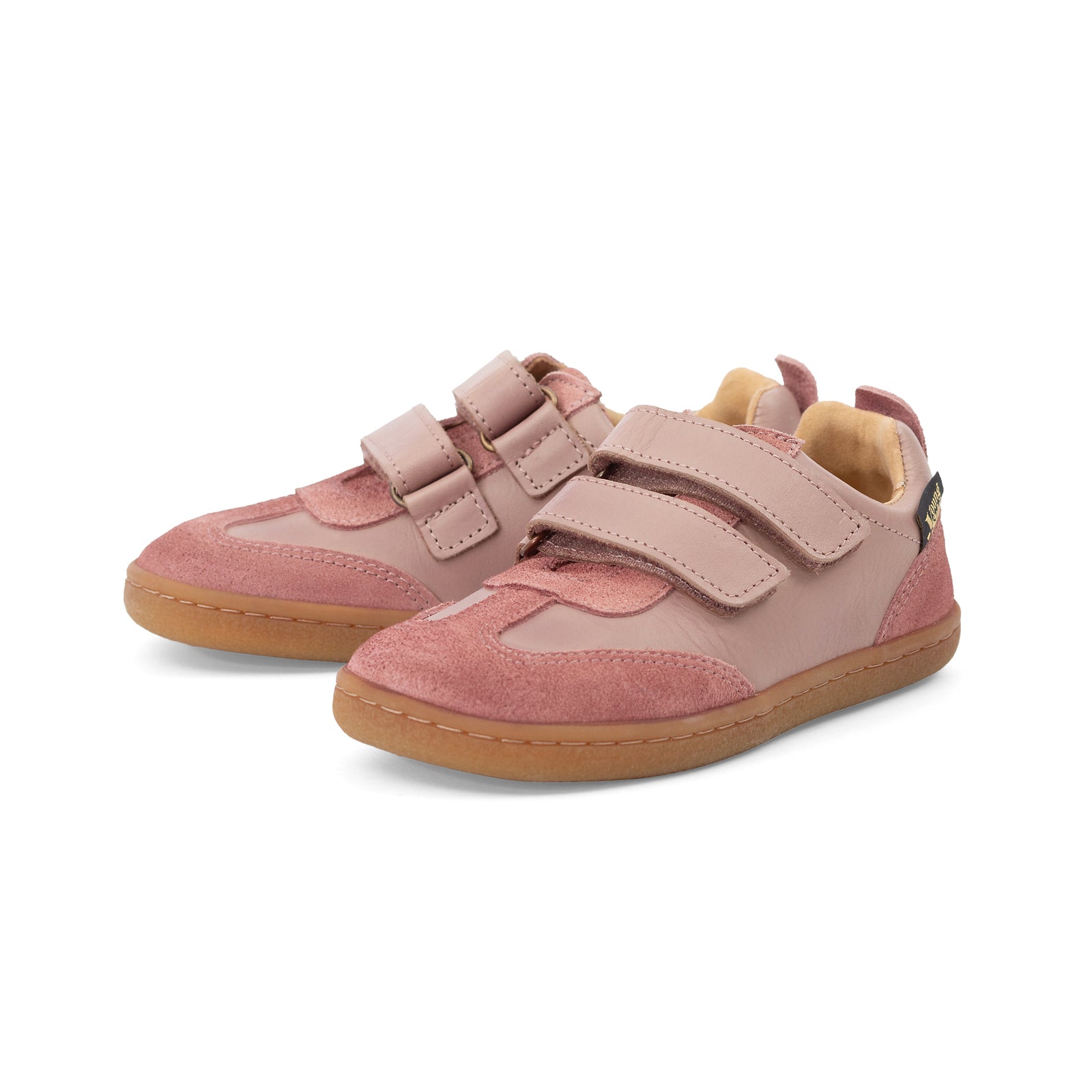 Pair of Pele pink barefoot children's shoes with velcro straps on a white background