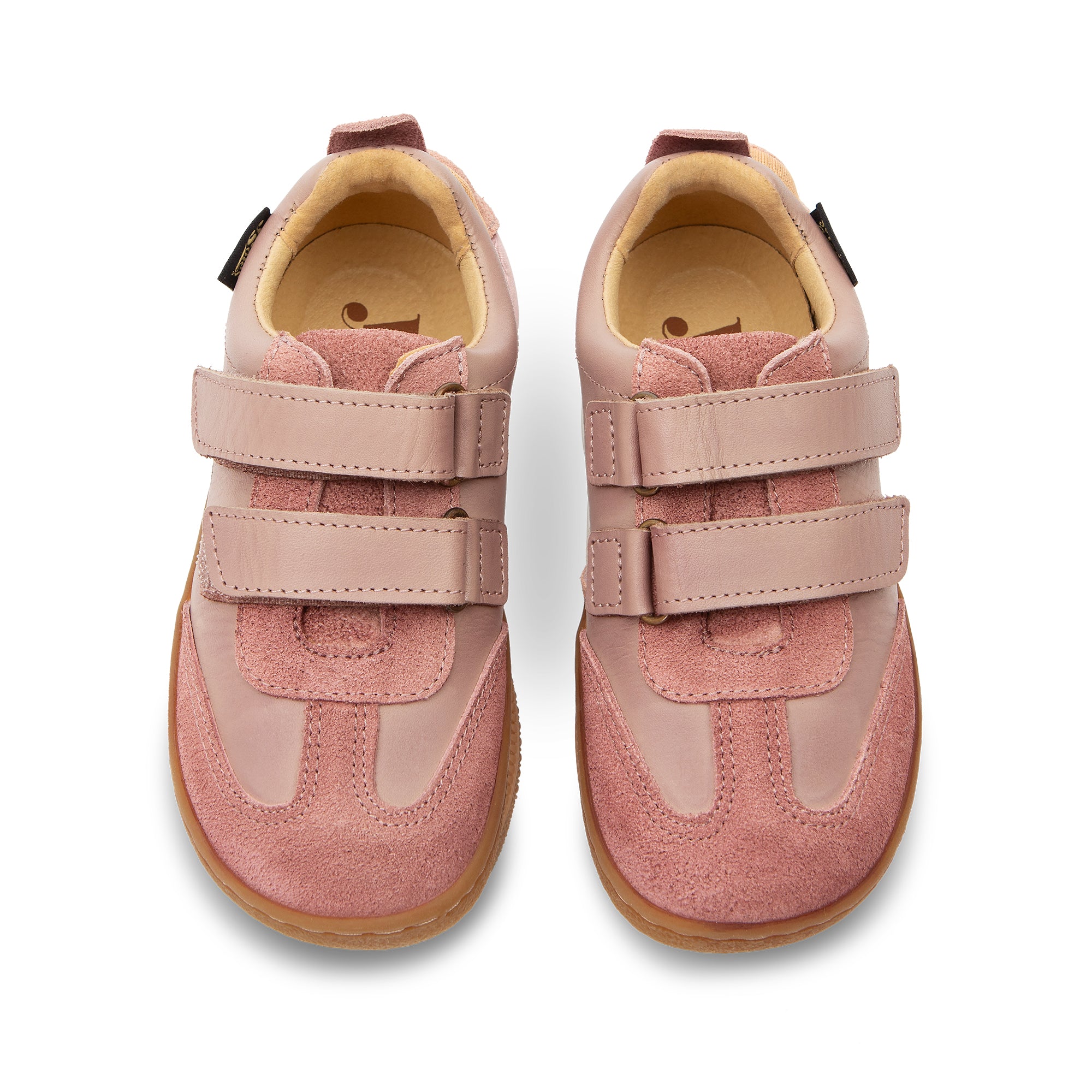 Pair of pink Pele children's barefoot shoes with velcro straps on a white background